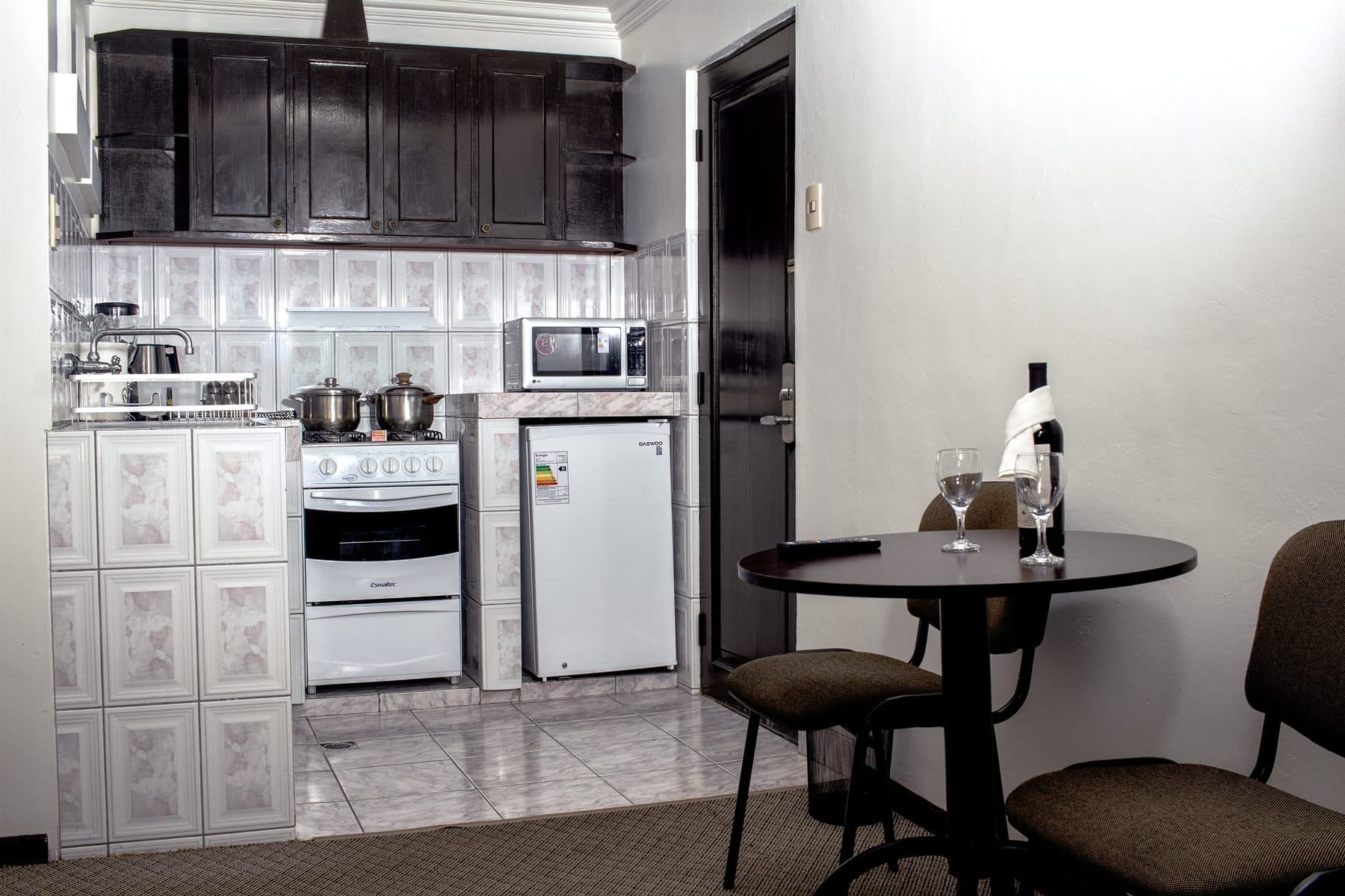 Bright white kitchenette with gas range and dining nook, finished by the Reborn group