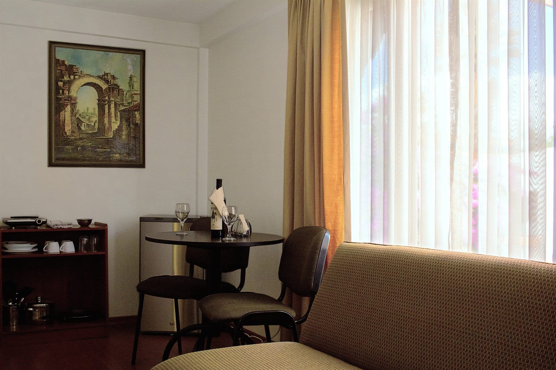 Sitting area with framed art, warm wood floors and lounge chair, finished by the Reborn group