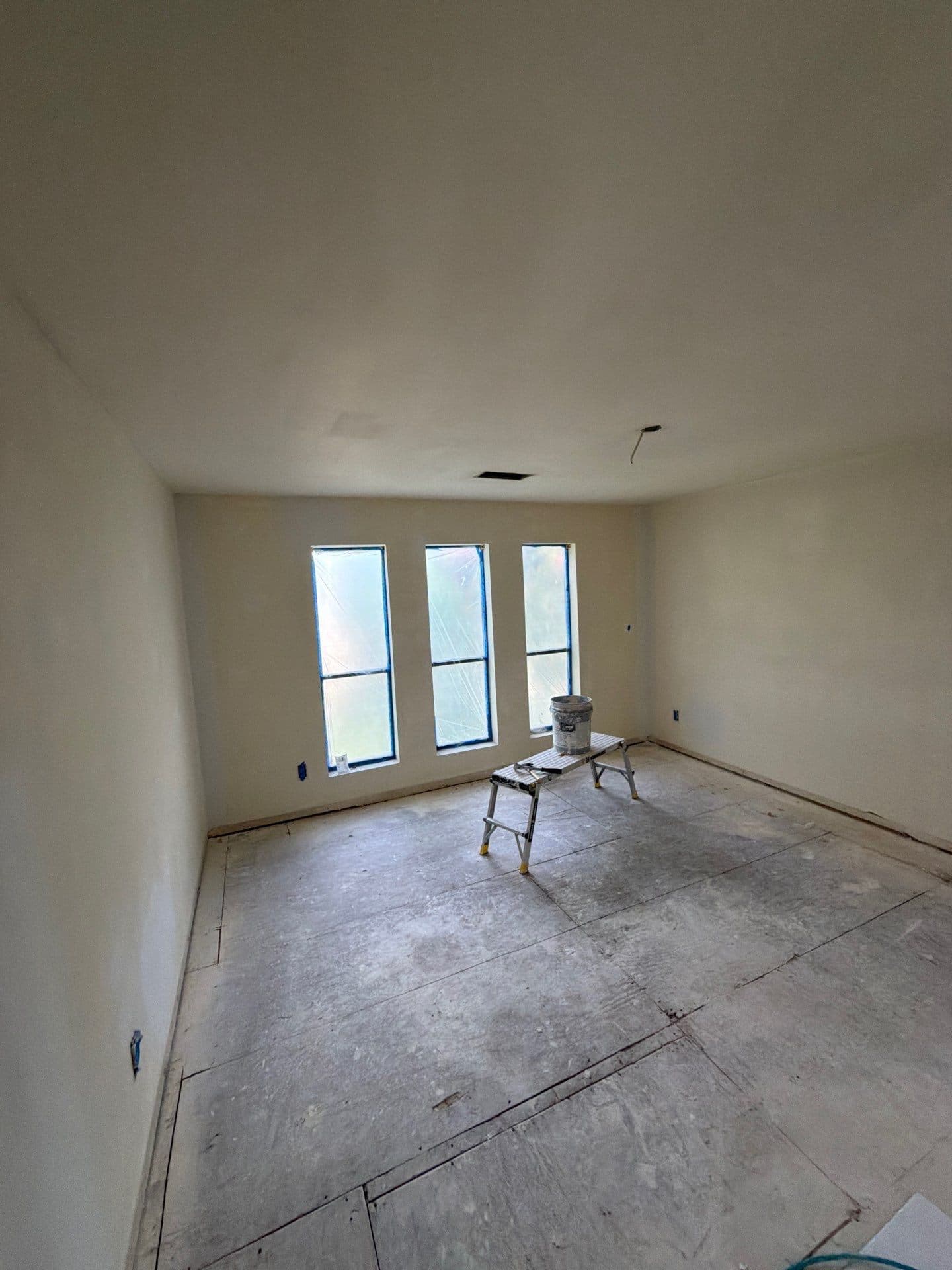 Triple-window room floated smooth and ready for paint