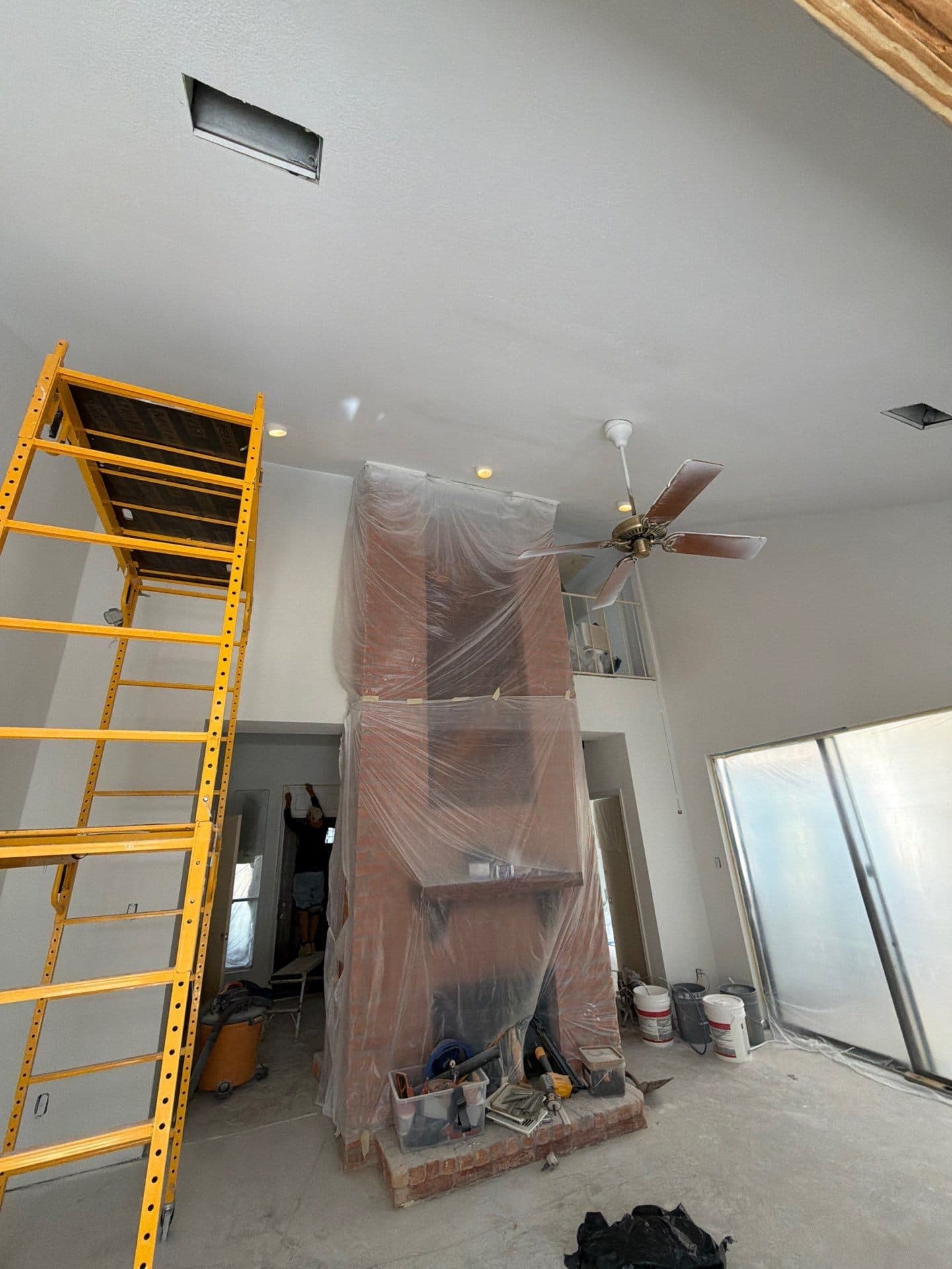 Scaffolding at the wrapped fireplace, vaulted walls freshly painted