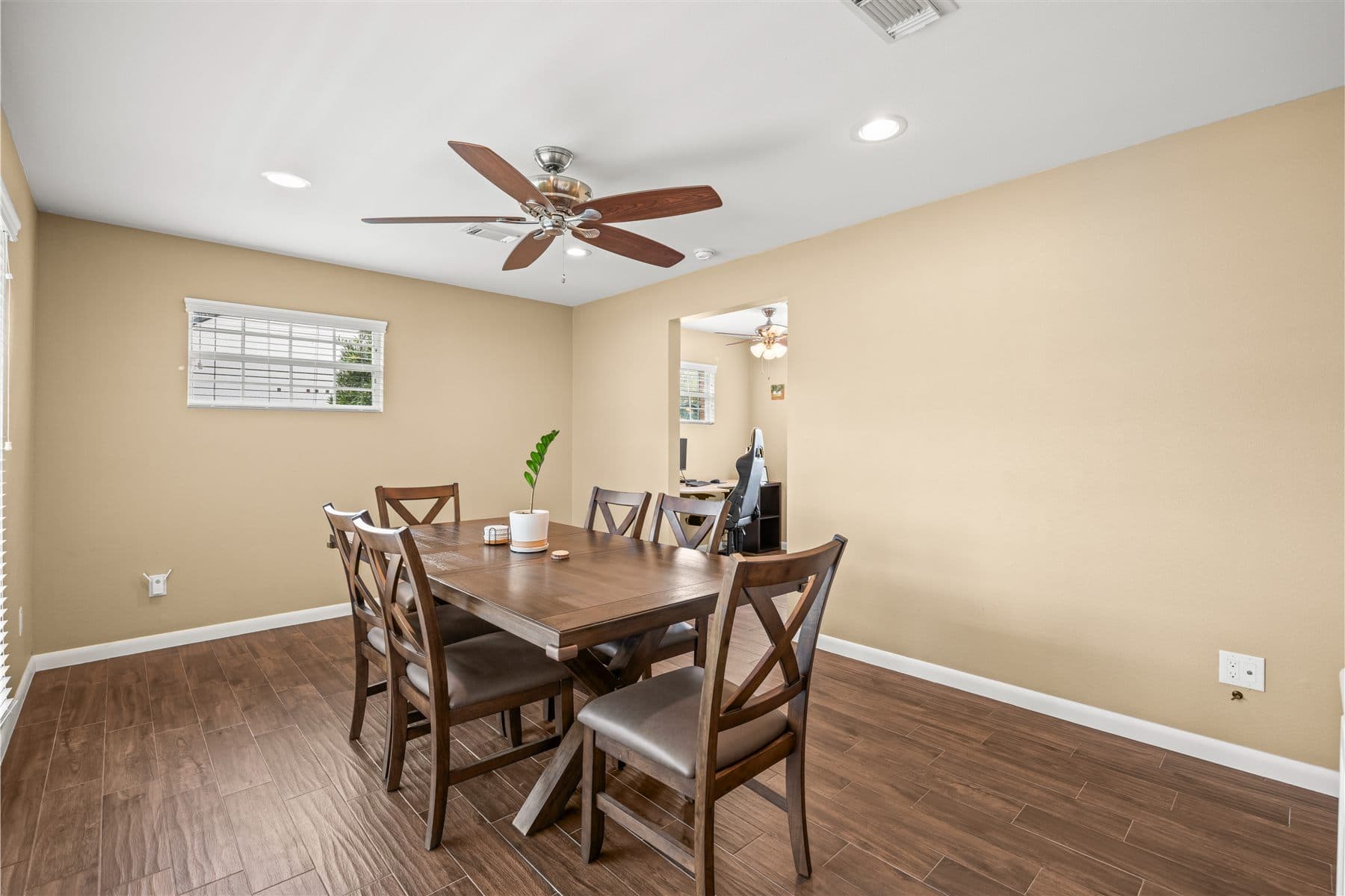Dining room with a wood farmhouse table and seating for six, furnished by the Reborn group