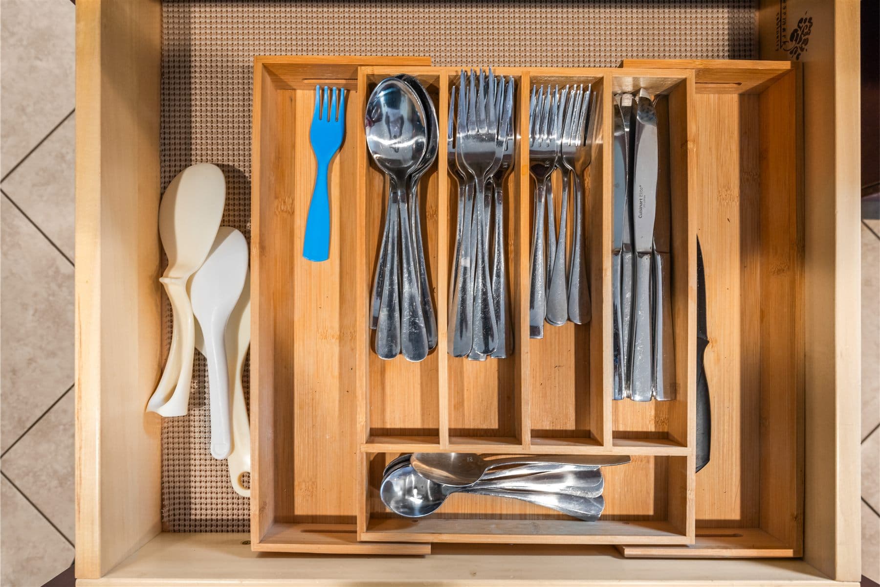Kitchen drawer with cutlery organized in a wood insert