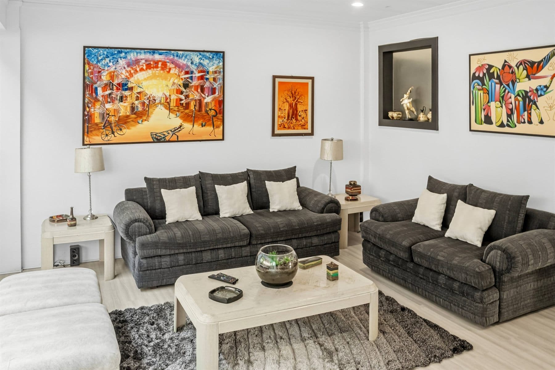 Living room with fireplace, gallery wall and plush sofas, finished by the Reborn group