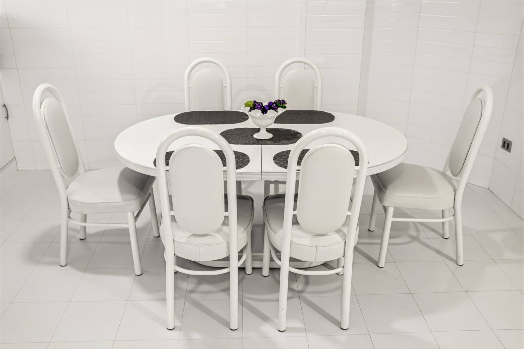 Round dining table for six with gallery art backdrop, finished by the Reborn group